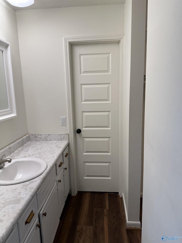 bathroom with vanity and hardwood / wood-style floors