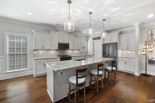 kitchen with a sink, high end refrigerator, black gas range, and dark wood finished floors