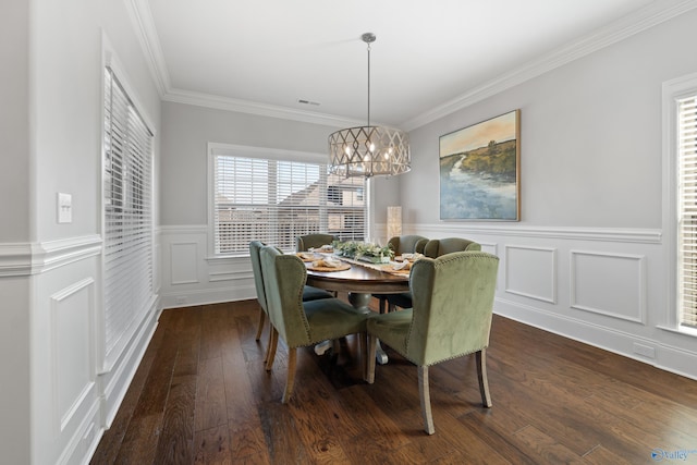 dining space featuring a notable chandelier, a wainscoted wall, dark wood-type flooring, visible vents, and ornamental molding