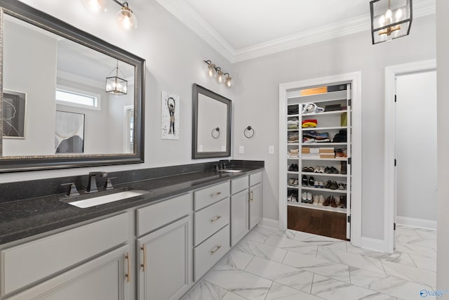 full bathroom featuring marble finish floor, ornamental molding, and a sink