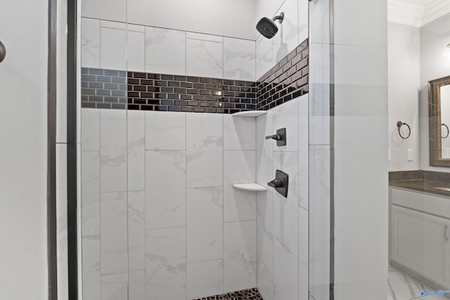 full bathroom with ornamental molding, a tile shower, and vanity