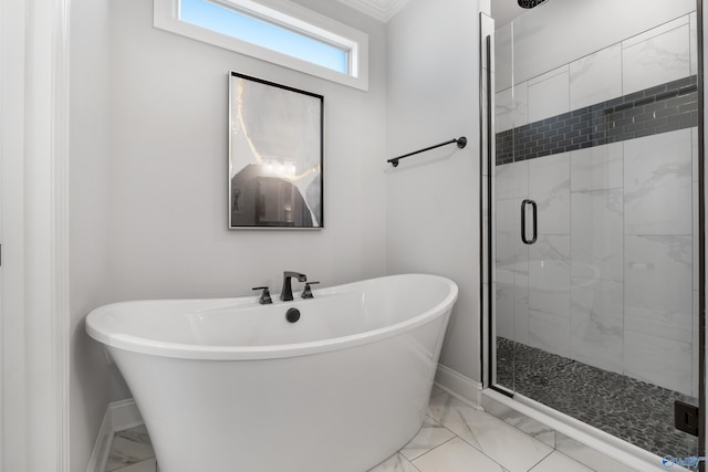 full bath featuring marble finish floor, a stall shower, a freestanding tub, and baseboards