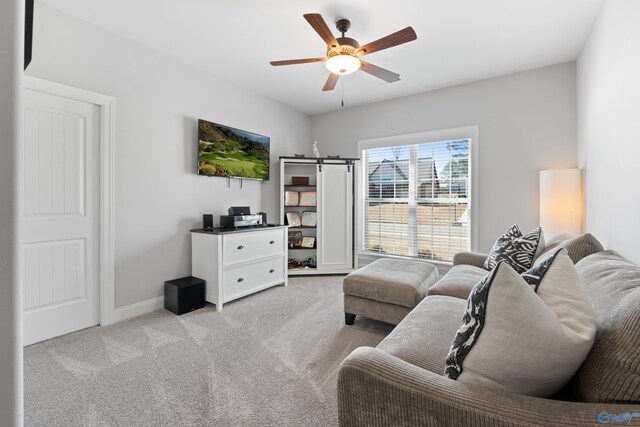 living area with light carpet, ceiling fan, and baseboards