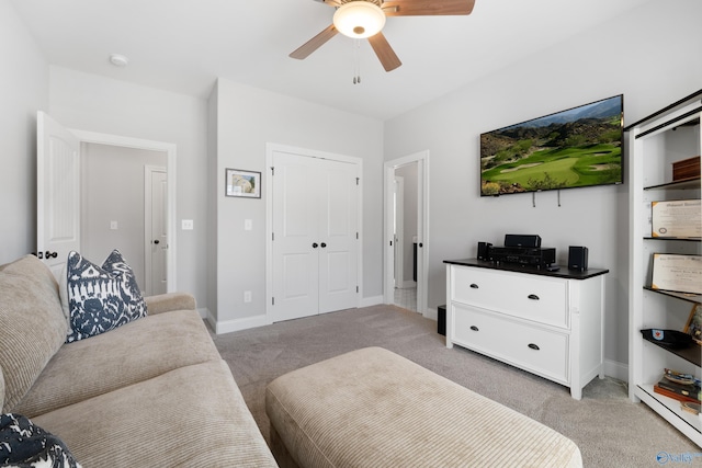 living room with light carpet, ceiling fan, and baseboards