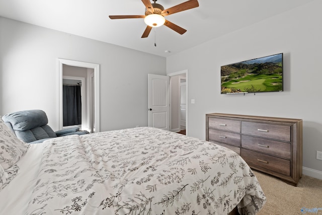 bedroom with a ceiling fan, light colored carpet, and baseboards