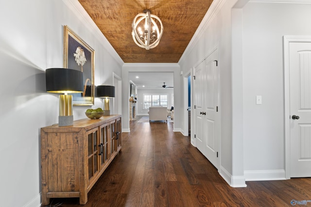 foyer with dark wood-style floors, crown molding, baseboards, and ceiling fan with notable chandelier