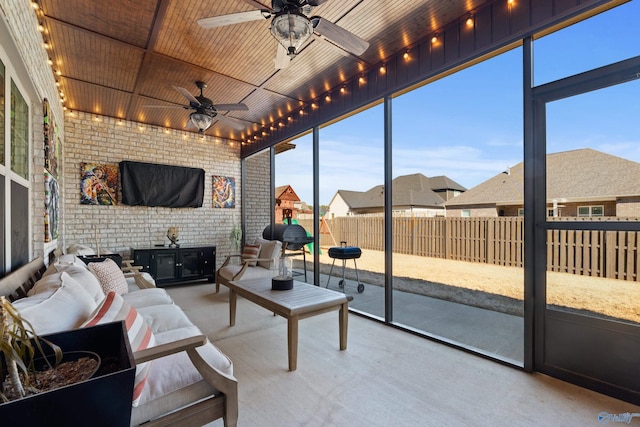 sunroom with wood ceiling and a ceiling fan