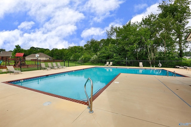 community pool featuring fence and a patio