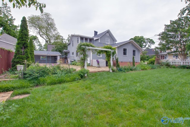 717 NE Eustis Ave, Huntsville, AL 35801 - rear view of property with a chimney