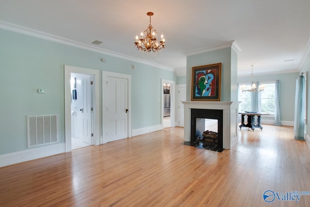 717 NE Eustis Ave, Huntsville, AL 35801 - living room featuring a chandelier, light wood-style floors, ornamental molding, baseboards, and a multi sided fireplace