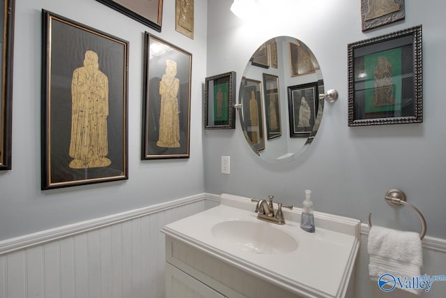 717 NE Eustis Ave, Huntsville, AL 35801 - bathroom featuring a wainscoted wall and vanity