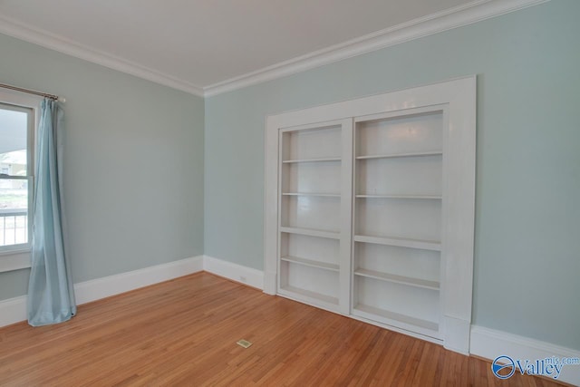717 NE Eustis Ave, Huntsville, AL 35801 - unfurnished room with ornamental molding, wood finished floors, and baseboards