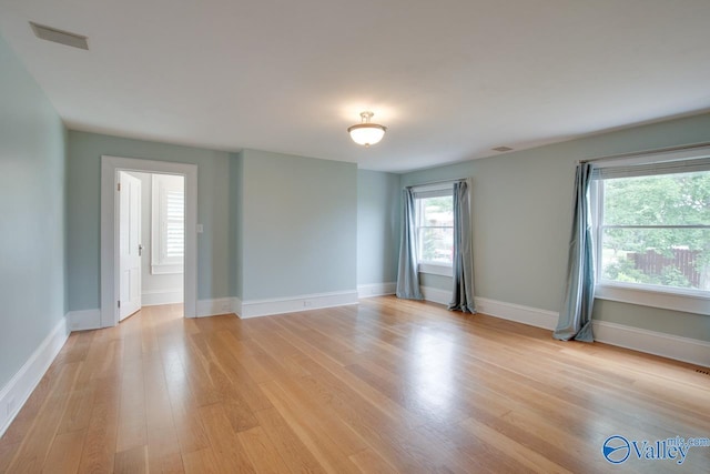 717 NE Eustis Ave, Huntsville, AL 35801 - spare room with light wood-style floors and baseboards