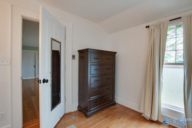717 NE Eustis Ave, Huntsville, AL 35801 - bedroom with light wood finished floors, lofted ceiling, and baseboards