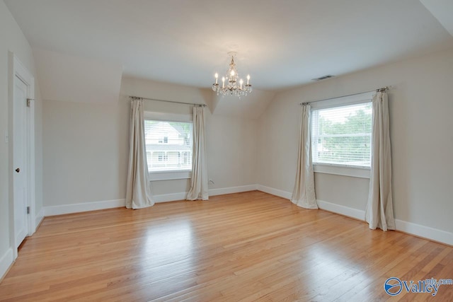 717 NE Eustis Ave, Huntsville, AL 35801 - unfurnished dining area featuring a chandelier, light wood finished floors, and baseboards