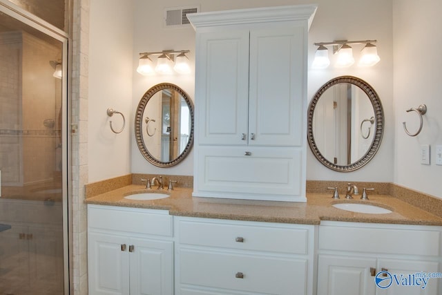 717 NE Eustis Ave, Huntsville, AL 35801 - bathroom with a shower stall and double vanity