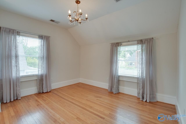 717 NE Eustis Ave, Huntsville, AL 35801 - additional living space featuring wood finished floors, vaulted ceiling, a chandelier, plenty of natural light, and baseboards