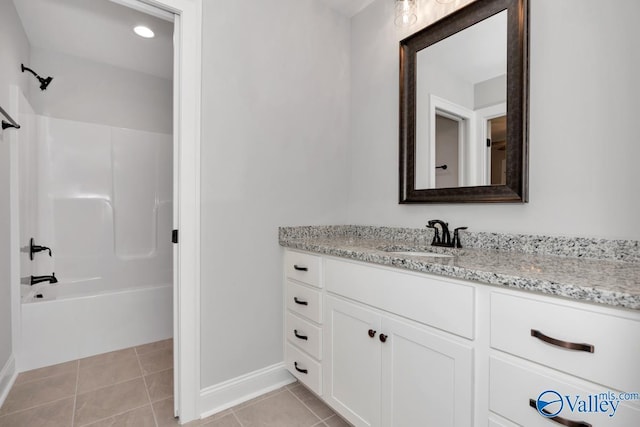 full bath with bathtub / shower combination, tile patterned flooring, vanity, and baseboards