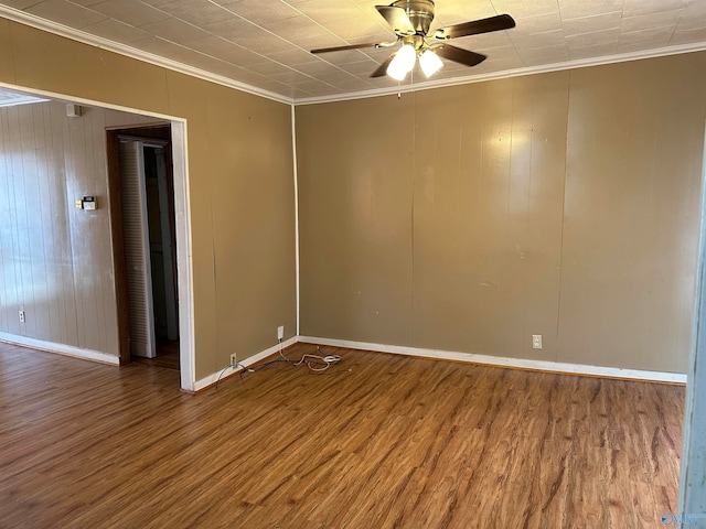 empty room featuring hardwood / wood-style floors, ceiling fan, and crown molding