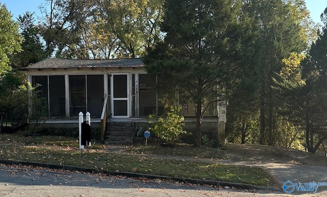 view of front of home featuring a sunroom