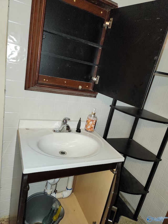 bathroom featuring vanity and backsplash