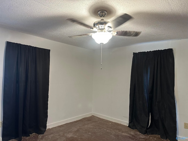 empty room featuring ceiling fan and a textured ceiling