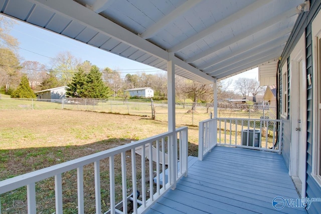 wooden terrace featuring central air condition unit, fence, and a yard