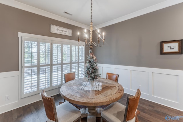 dining area featuring a wealth of natural light, dark wood-type flooring, a notable chandelier, and ornamental molding