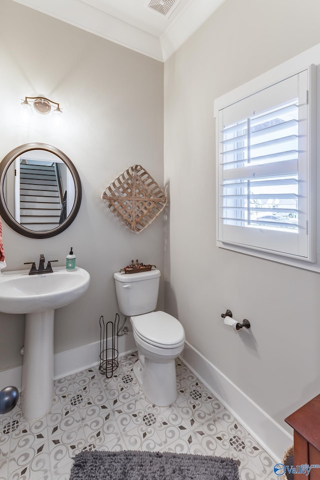 bathroom featuring tile patterned floors, toilet, ornamental molding, and sink