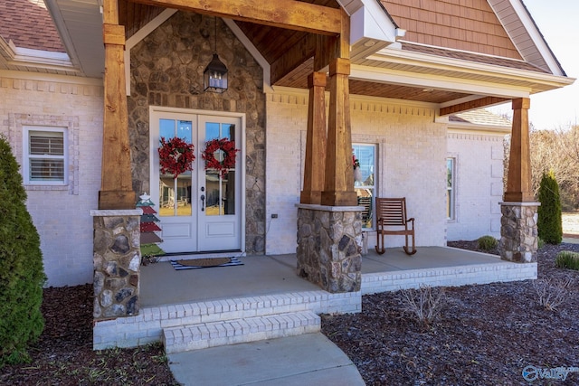 doorway to property with a porch and french doors