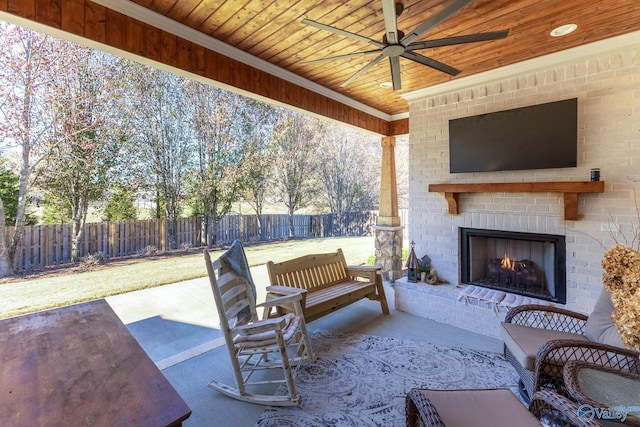 view of patio with an outdoor brick fireplace and ceiling fan