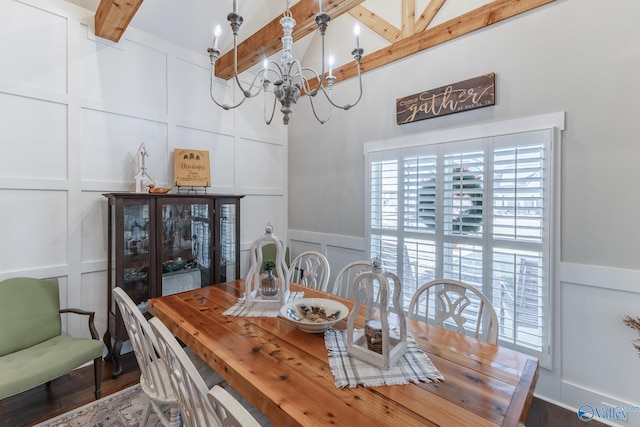 dining area with lofted ceiling with beams, hardwood / wood-style flooring, and an inviting chandelier