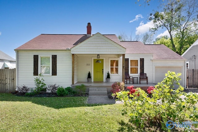 view of front of house with a porch, a chimney, fence, a garage, and a front yard