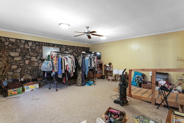 bedroom with ornamental molding, a textured ceiling, ceiling fan, and carpet flooring