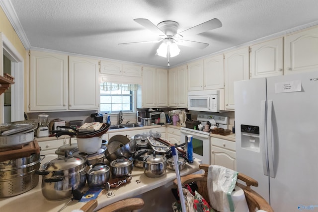 kitchen with white appliances, a ceiling fan, a textured ceiling, and a sink