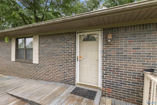property entrance featuring brick siding