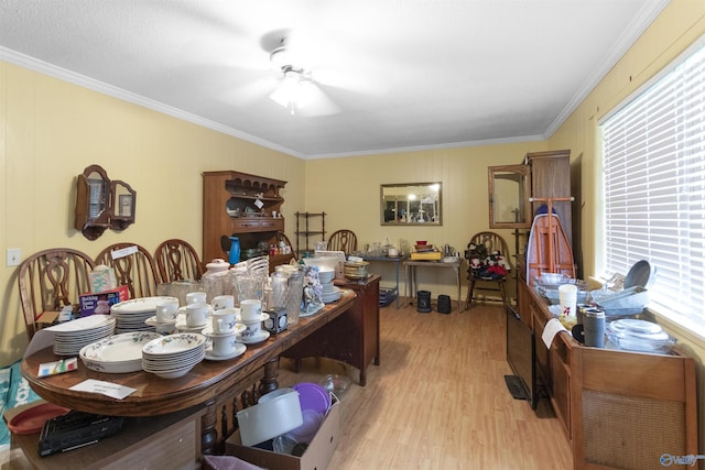 dining space featuring light wood-style floors, ornamental molding, and ceiling fan