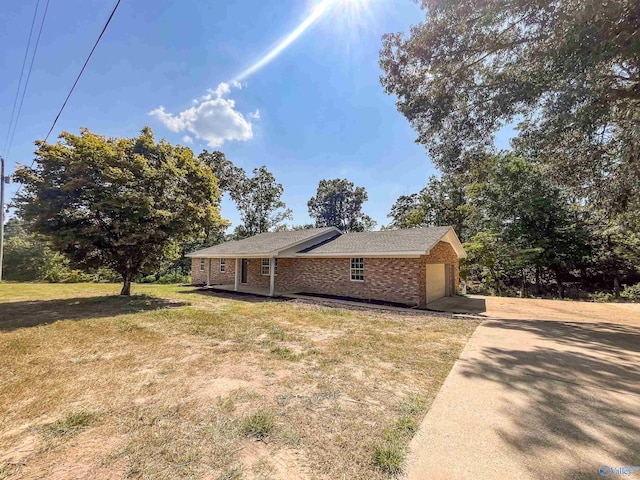 view of property exterior with a garage and a lawn