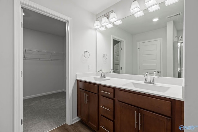 bathroom with vanity and hardwood / wood-style flooring