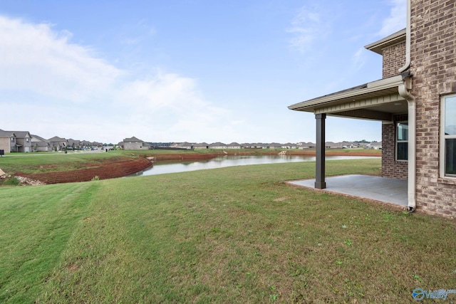 view of yard featuring a patio and a water view