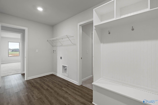 washroom with hookup for an electric dryer and dark wood-type flooring