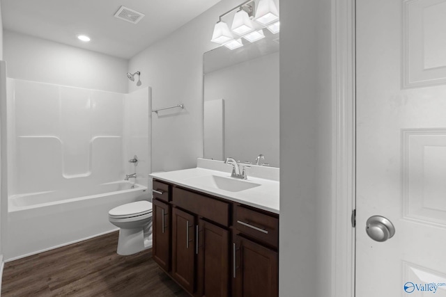 full bathroom featuring vanity, hardwood / wood-style floors, toilet, and shower / bathtub combination