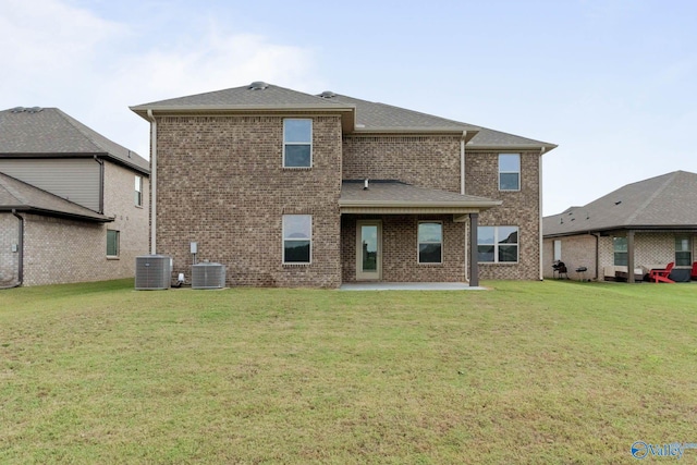 rear view of property with cooling unit, a patio area, and a yard