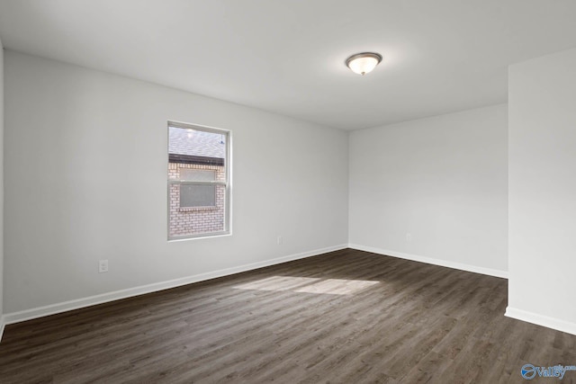 unfurnished room featuring dark wood-type flooring