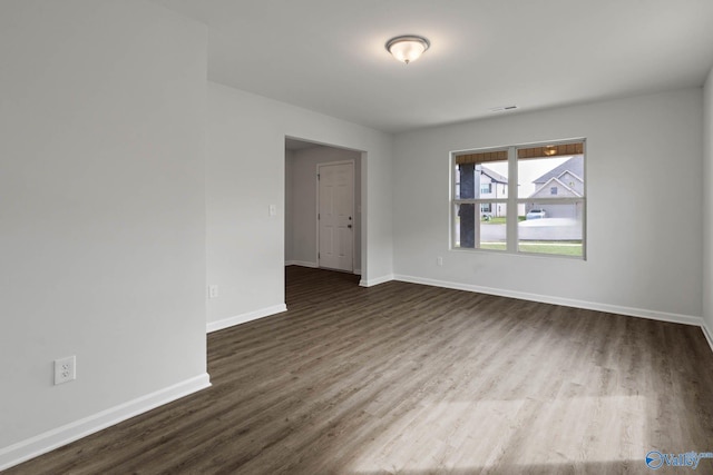 spare room featuring dark wood-type flooring