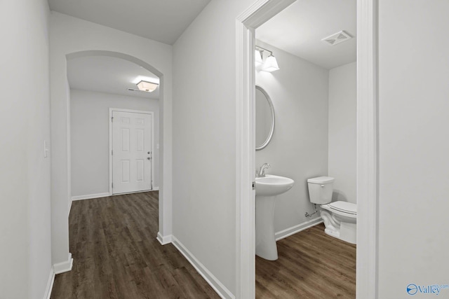 hall featuring dark hardwood / wood-style floors and sink