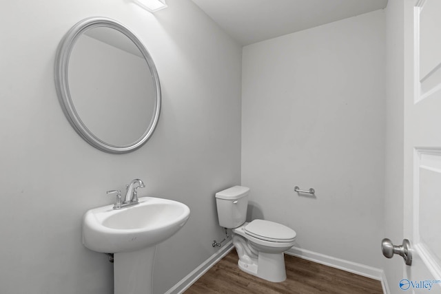 bathroom with wood-type flooring and toilet