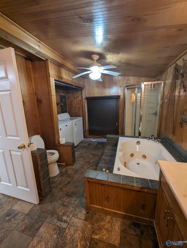 bathroom with wooden walls, wood ceiling, washer and clothes dryer, toilet, and ceiling fan