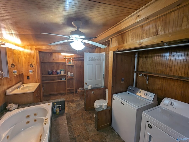 clothes washing area featuring wood walls, ceiling fan, and wood ceiling