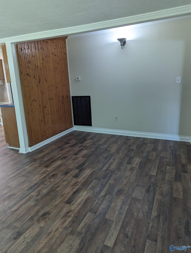 unfurnished room featuring hardwood / wood-style flooring, crown molding, and a textured ceiling